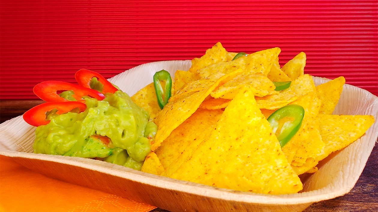 Tortilla Chips in Guacamole Tortilla Chips in Guacamole