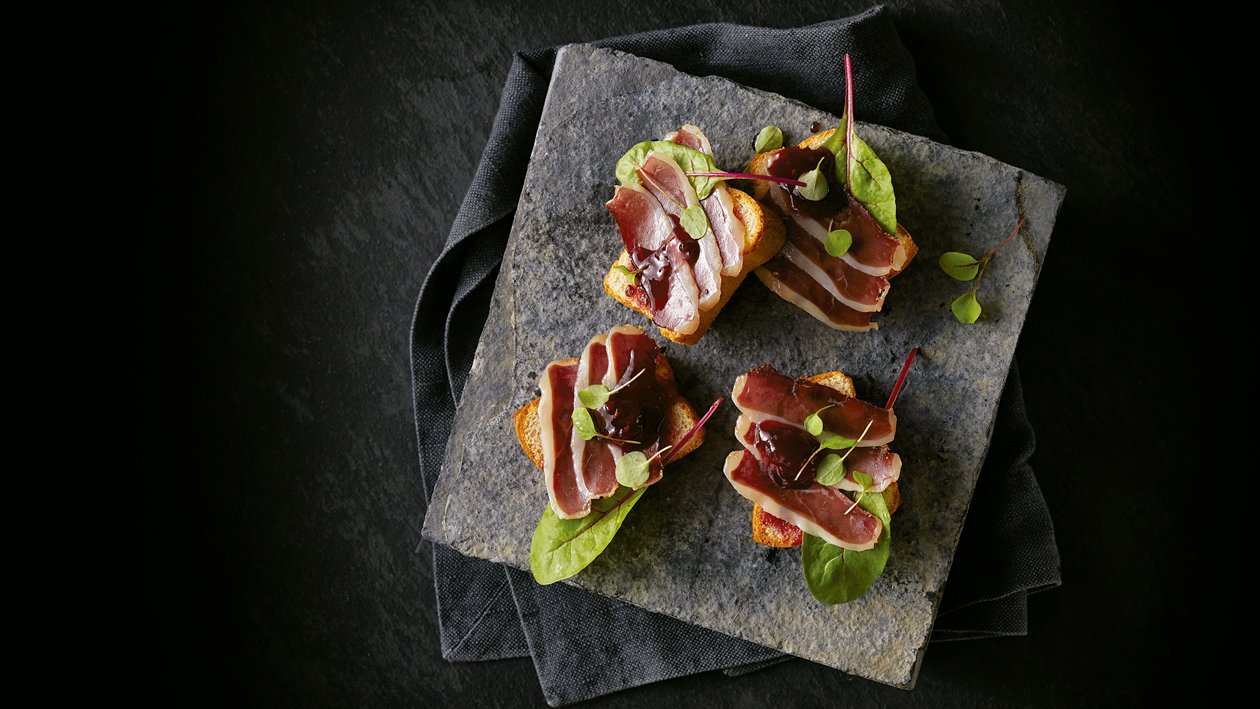 Emparedado de pan de brioche con pato ahumado y mermelada de frutos rojos Emparedado de pan de brioche con pato ahumado y mermelada de frutos rojos