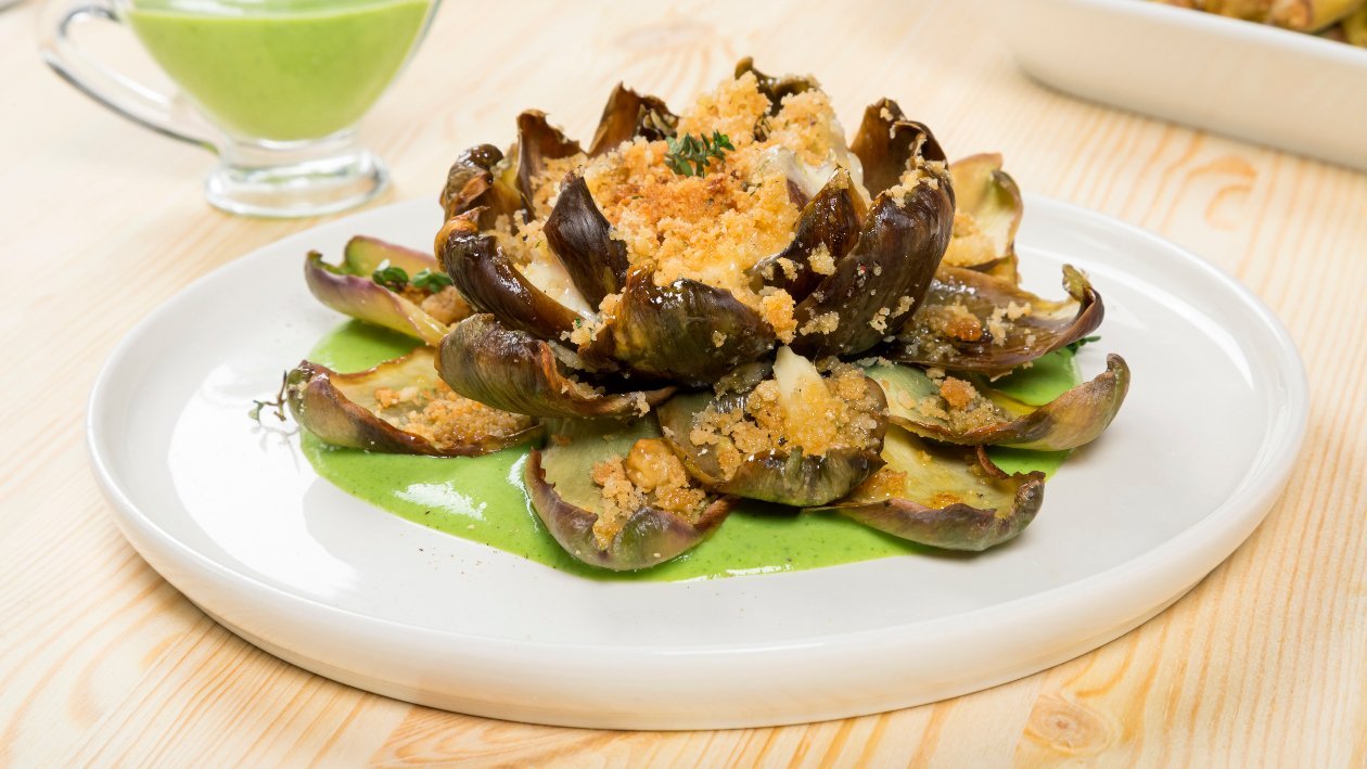Fiore di carciofo gratinato con cuore fondente di provola affumicata e salsa verde al parmigiano – Ricetta Fiore di carciofo gratinato con cuore fondente di provola affumicata e salsa verde al parmigiano – Ricetta